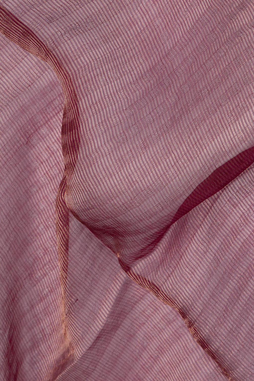 Close up of Pure Silk Magenta Dual Tone Tussar Saree with Stripes on the body and Sequin Border.  displaying folds