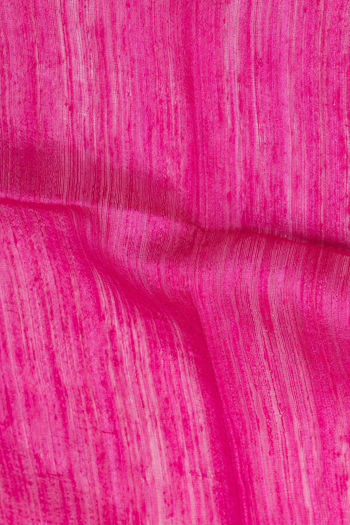 Close up of Pink Tussar Saree with Plain Body and Fancy Border.  displaying folds