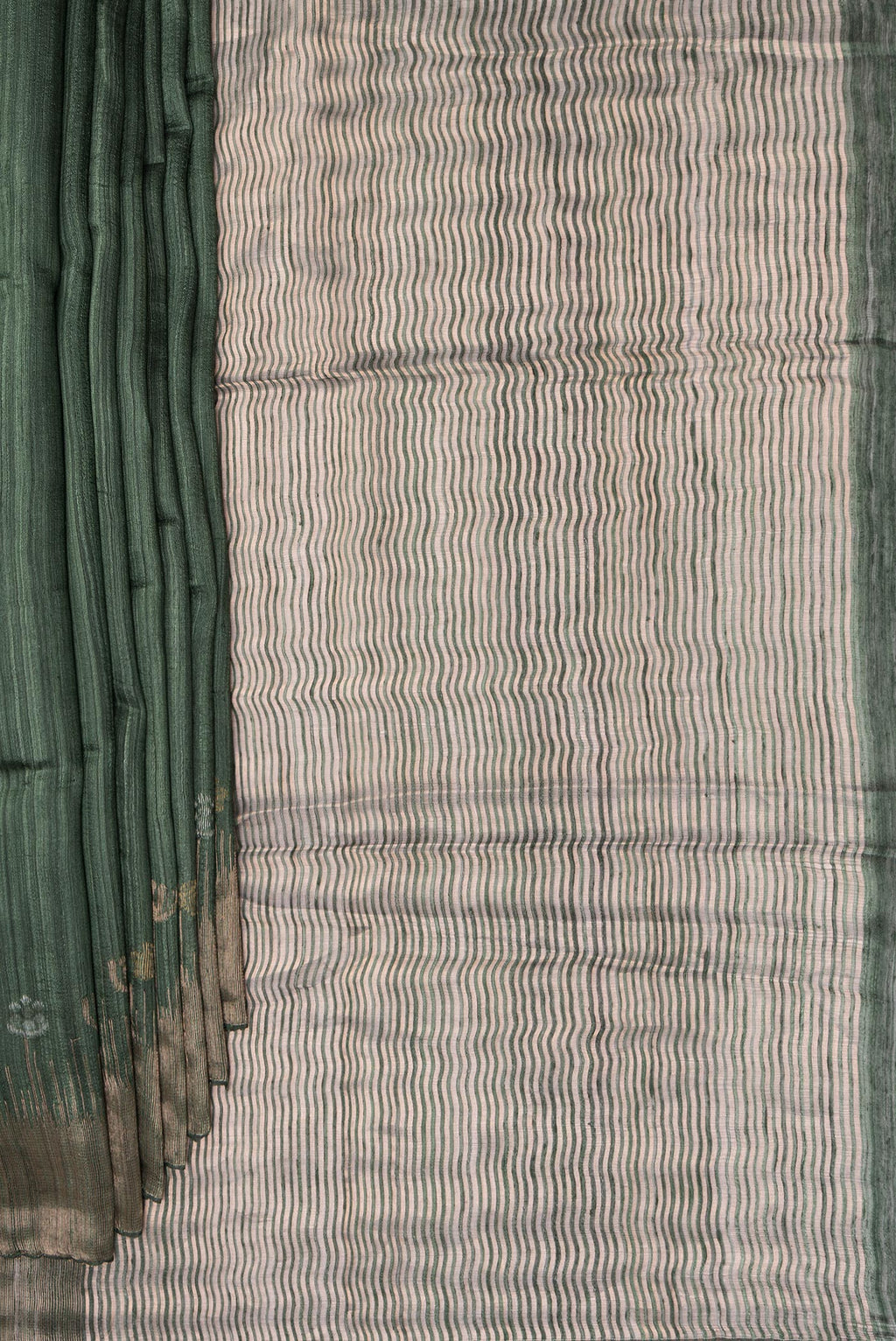 Pleats and pallu of Bottle Green Tussar Saree with Zari Butta on the body and Fancy Border. 