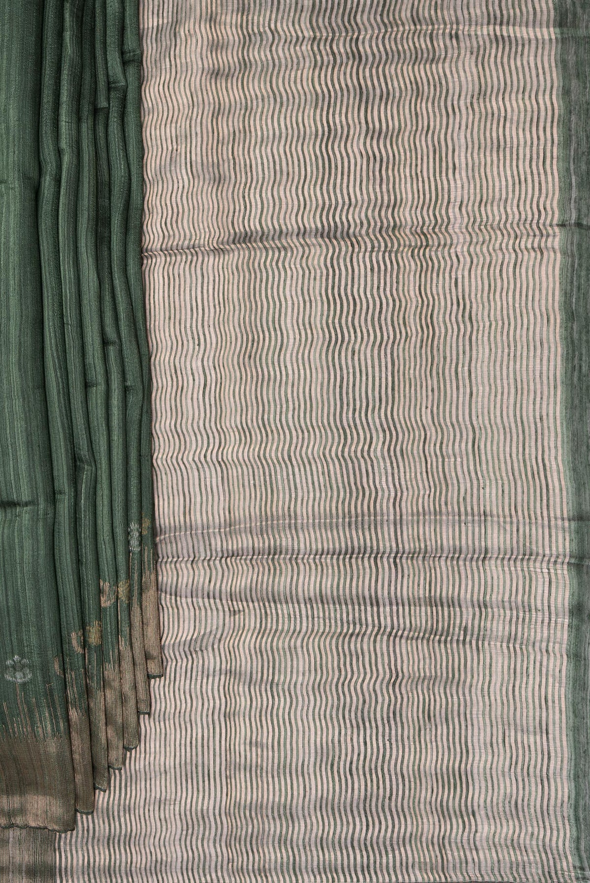 Pleats and pallu of Bottle Green Tussar Saree with Zari Butta on the body and Fancy Border. 