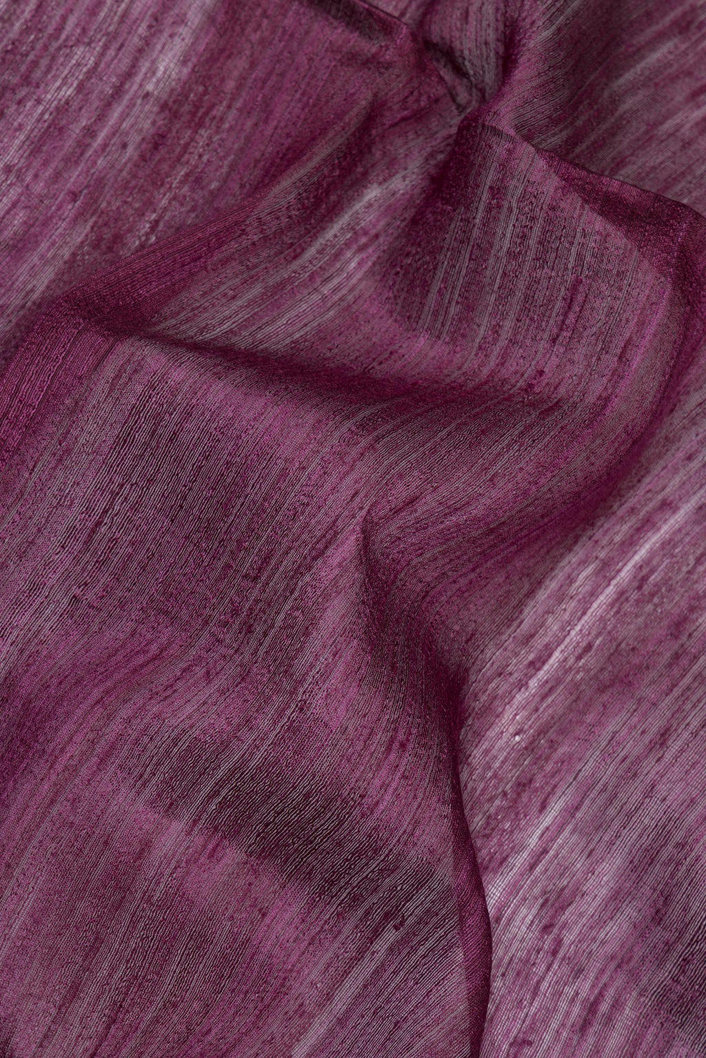 Close up of Pure Silk Purple Dual Tone Jute Saree with Zari Butta on the body and Fancy Border.  displaying folds