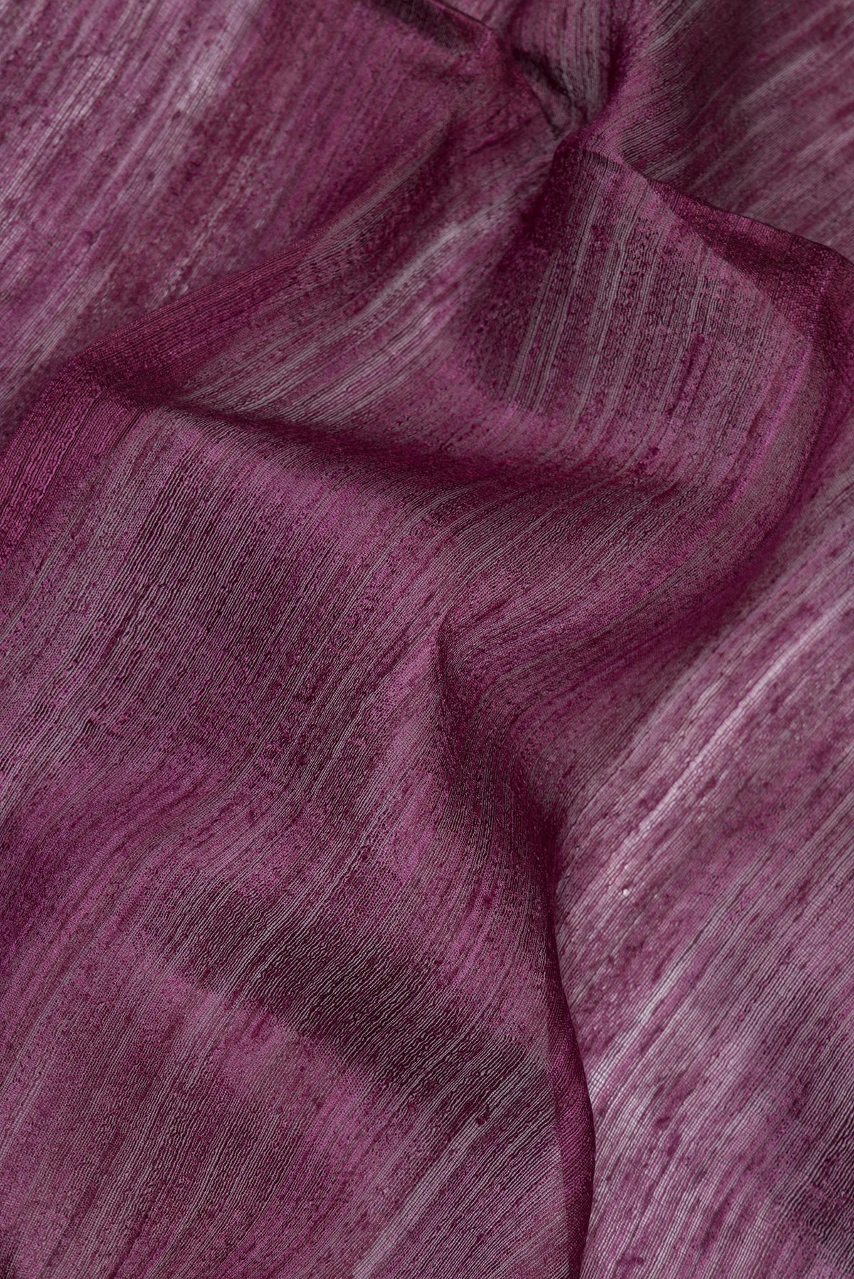 Close up of Pure Silk Purple Dual Tone Jute Saree with Zari Butta on the body and Fancy Border.  displaying folds