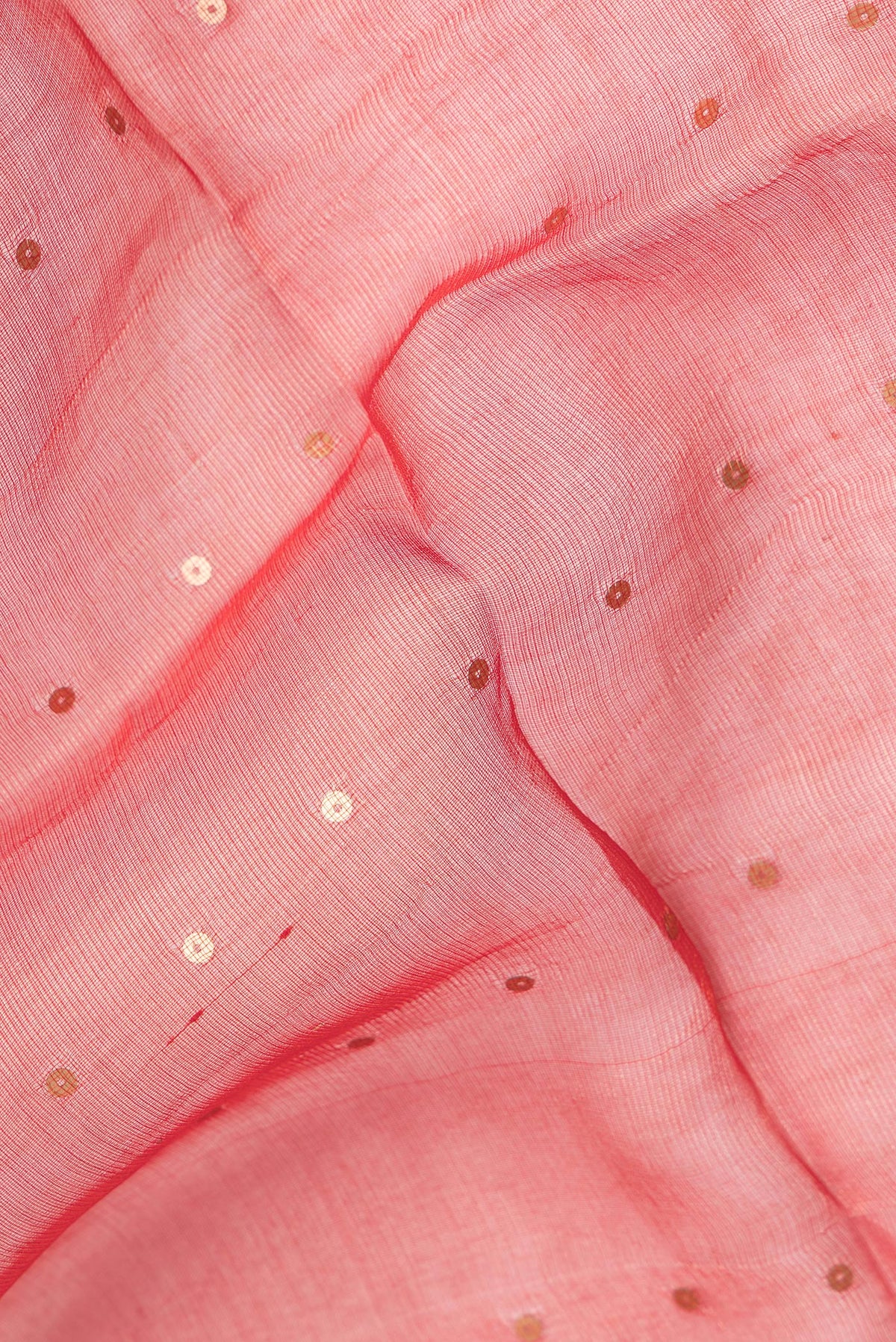 Close up of Pure Silk Red Tussar Saree with Embroidery on the body and Zari Border.  displaying folds