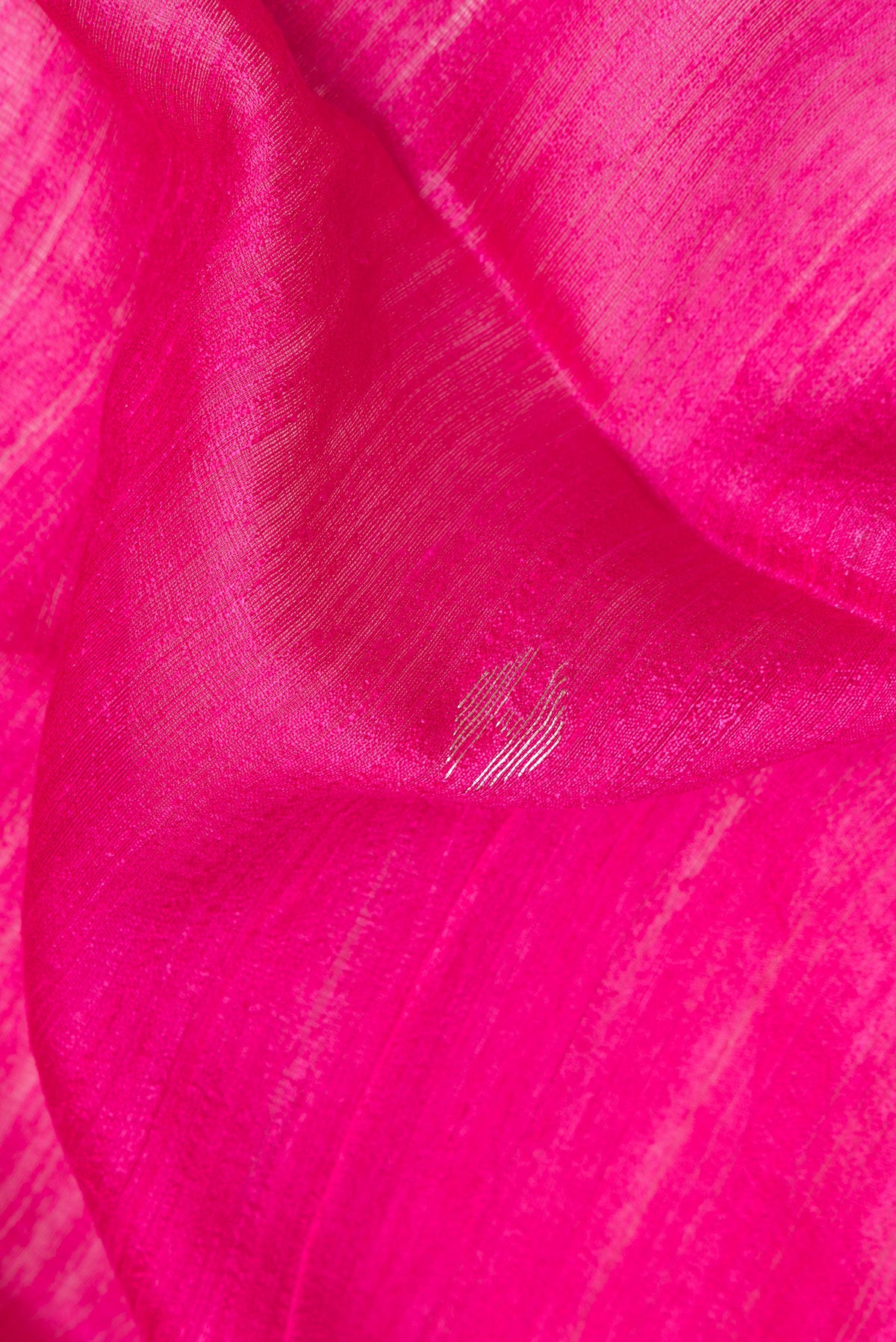 Close up of Pure Silk Pink Tussar Saree with Zari Butta on the body and Zari Border.  displaying folds