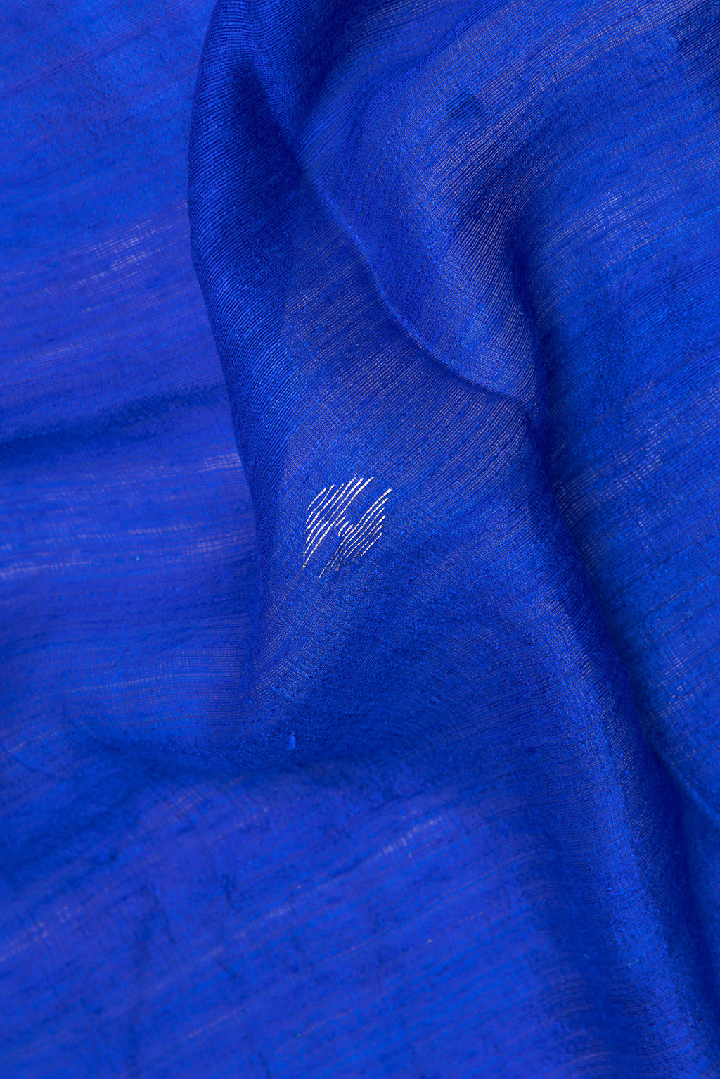 Close up of Royal Blue Tussar Saree with Zari Butta on the body and Zari Border.  displaying folds