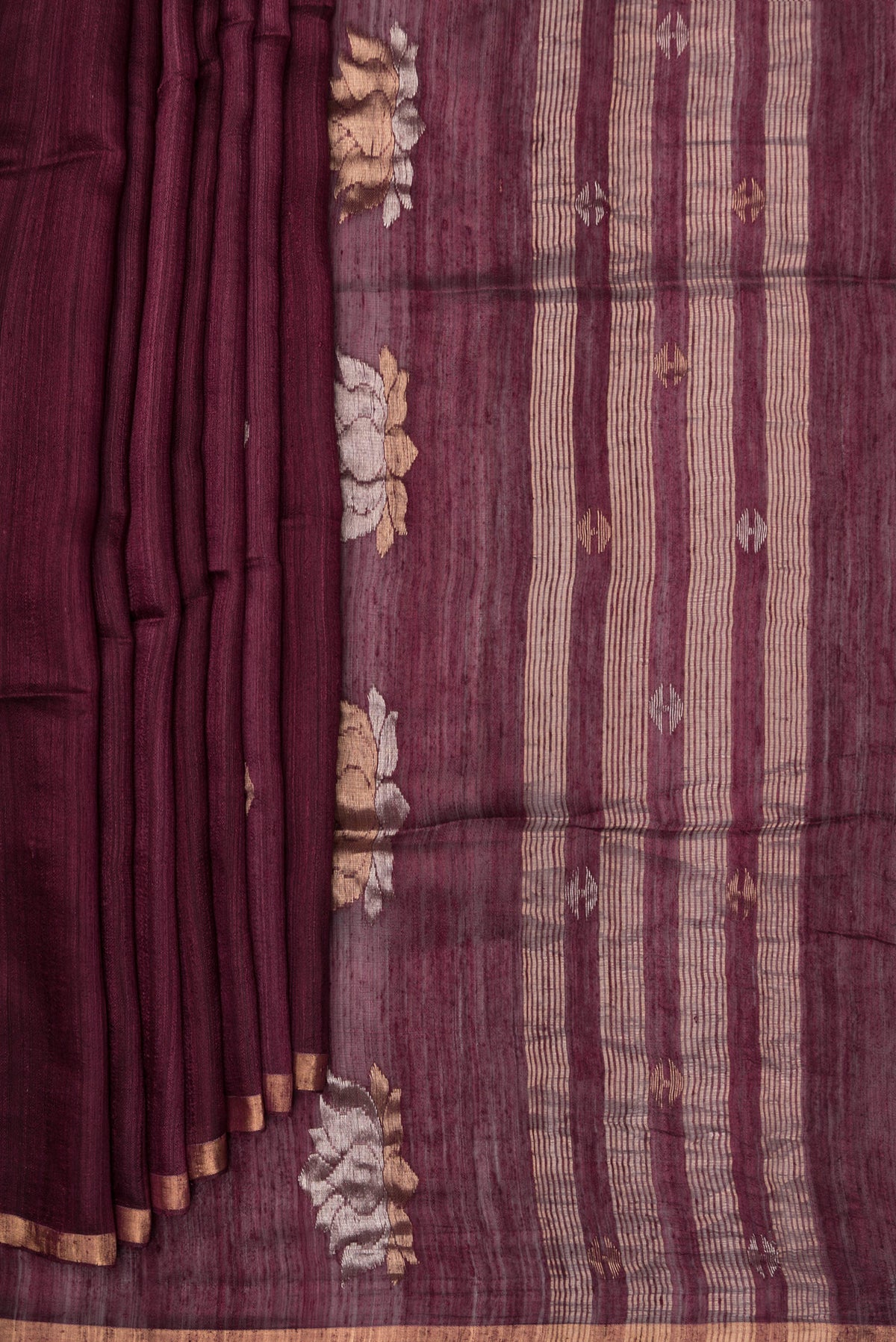 Pleats and pallu of Pure Silk Brown Tussar Saree with Zari Butta on the body and Zari Border. 