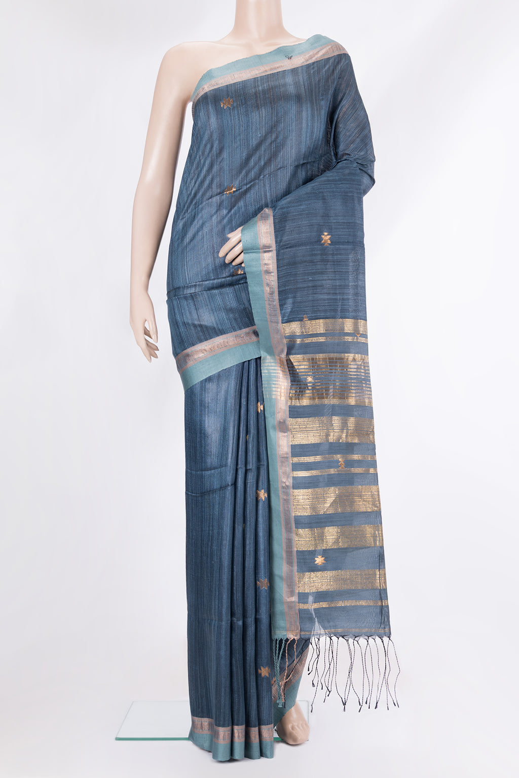 Grey Tussar Saree with Zari Butta on the body and Zari Border.  displayed on a mannequin