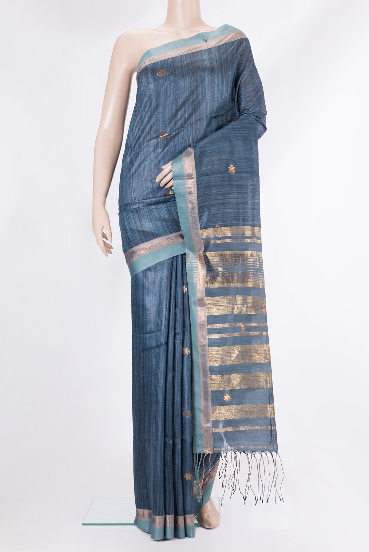 Grey Tussar Saree with Zari Butta on the body and Zari Border.  displayed on a mannequin