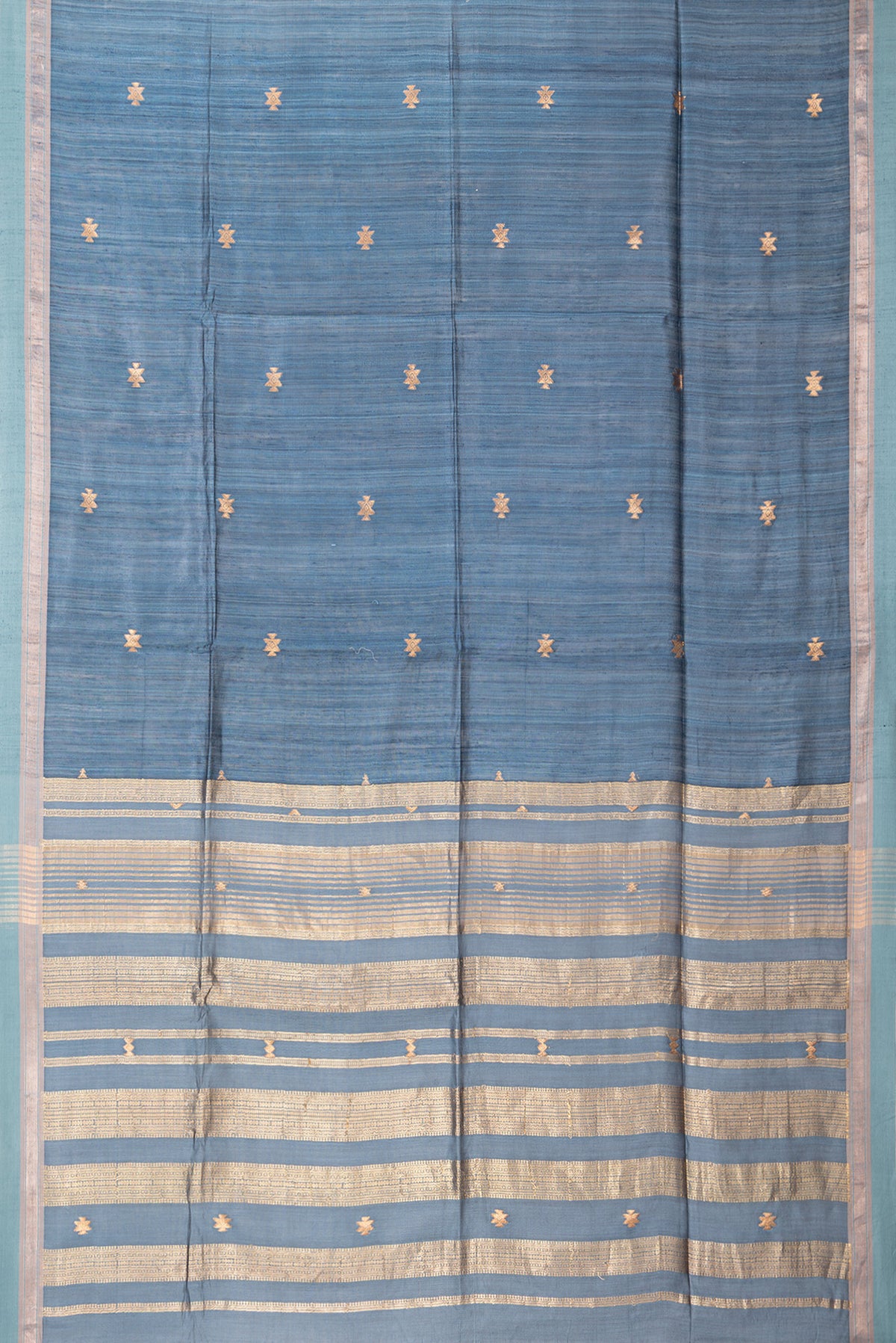 Flat view of Grey Tussar Saree with Zari Butta on the body and Zari Border. 