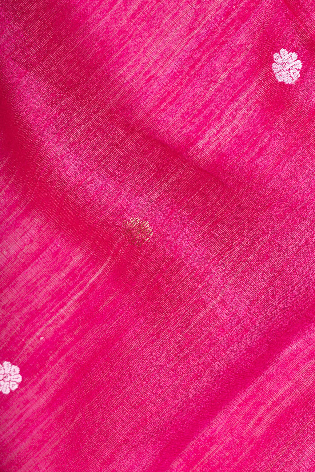 Close up of Pure Silk Pink Tussar Saree with Zari Butta on the body and Zari Border.  displaying folds