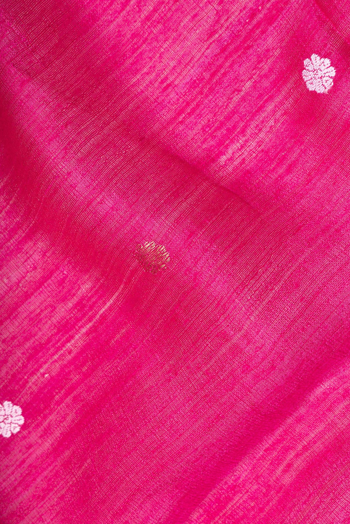Close up of Pure Silk Pink Tussar Saree with Zari Butta on the body and Zari Border.  displaying folds