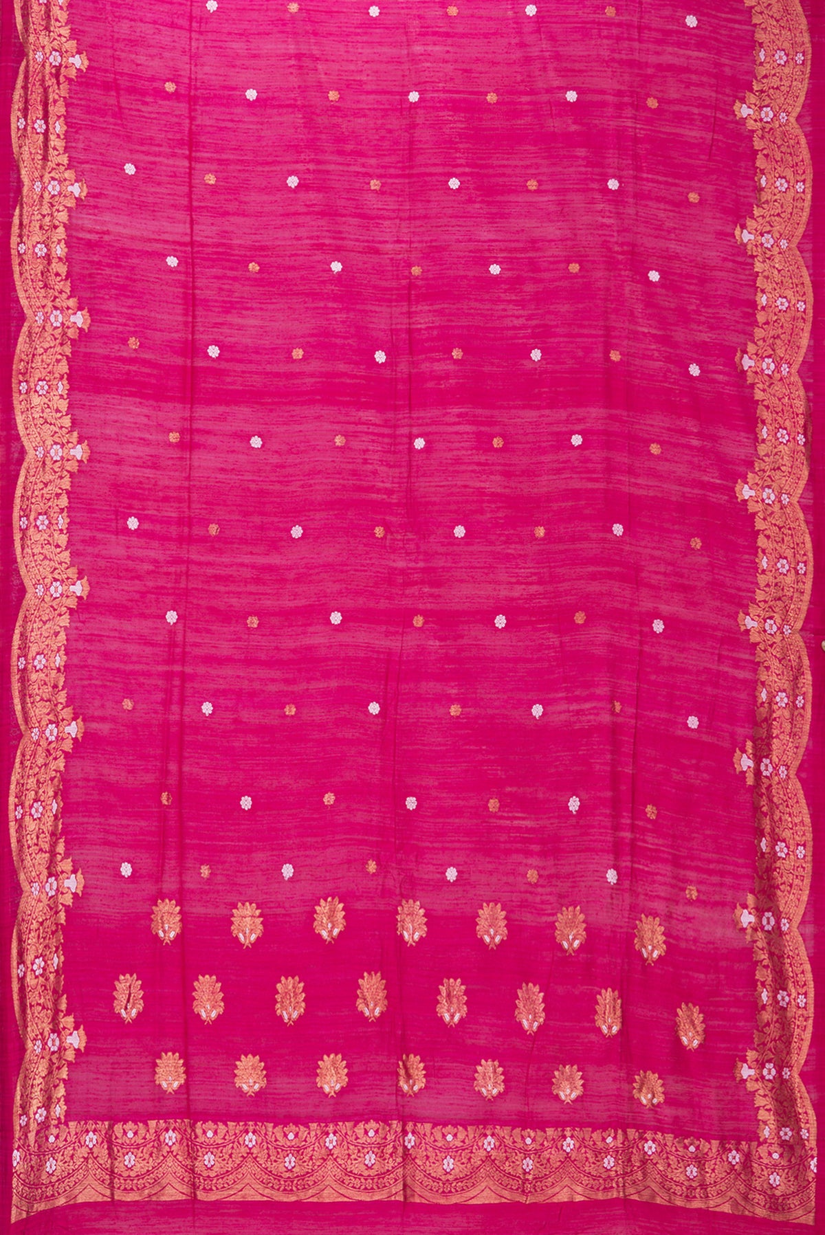 Flat view of Pure Silk Pink Tussar Saree with Zari Butta on the body and Zari Border. 