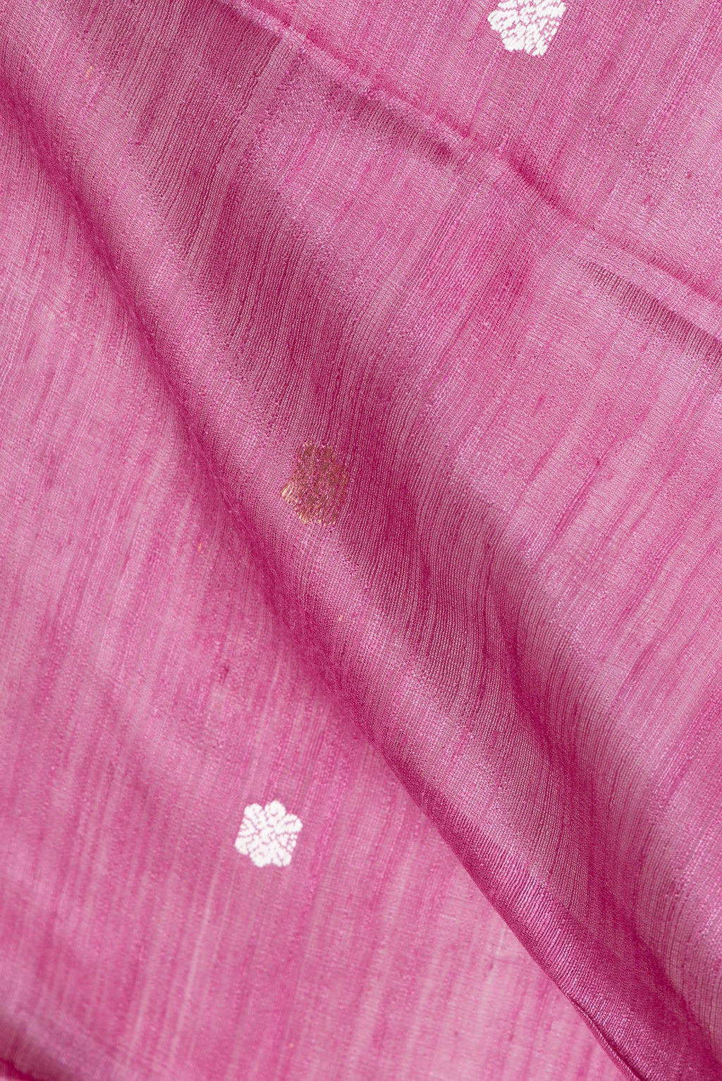 Close up of Pink Tussar Saree with Zari Butta on the body and Fancy Border.  displaying folds