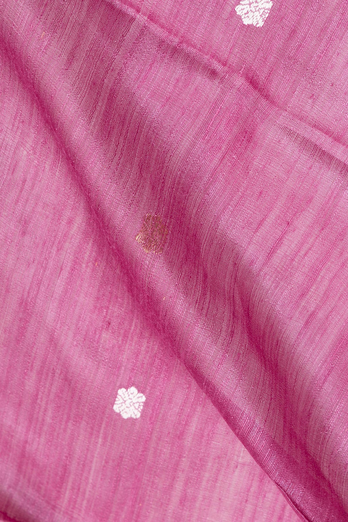 Close up of Pink Tussar Saree with Zari Butta on the body and Fancy Border.  displaying folds