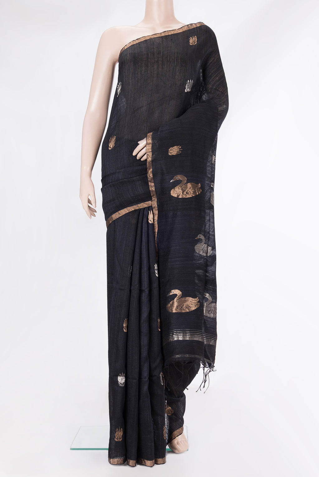 Black Tussar Saree with Zari Butta on the body and Zari Border.  displayed on a mannequin