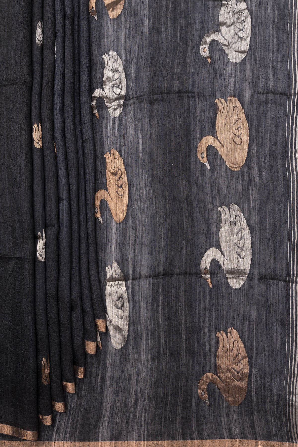 Pleats and pallu of Black Tussar Saree with Zari Butta on the body and Zari Border. 
