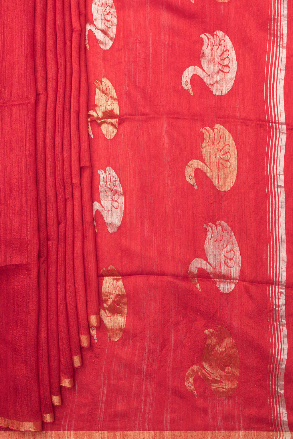 Pleats and pallu of Red Tussar Saree with Zari Butta on the body and Zari Border. 