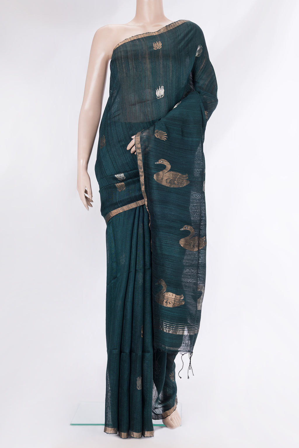 Pure Silk Bottle Green Tussar Saree with Zari Butta on the body and Zari Border.  displayed on a mannequin