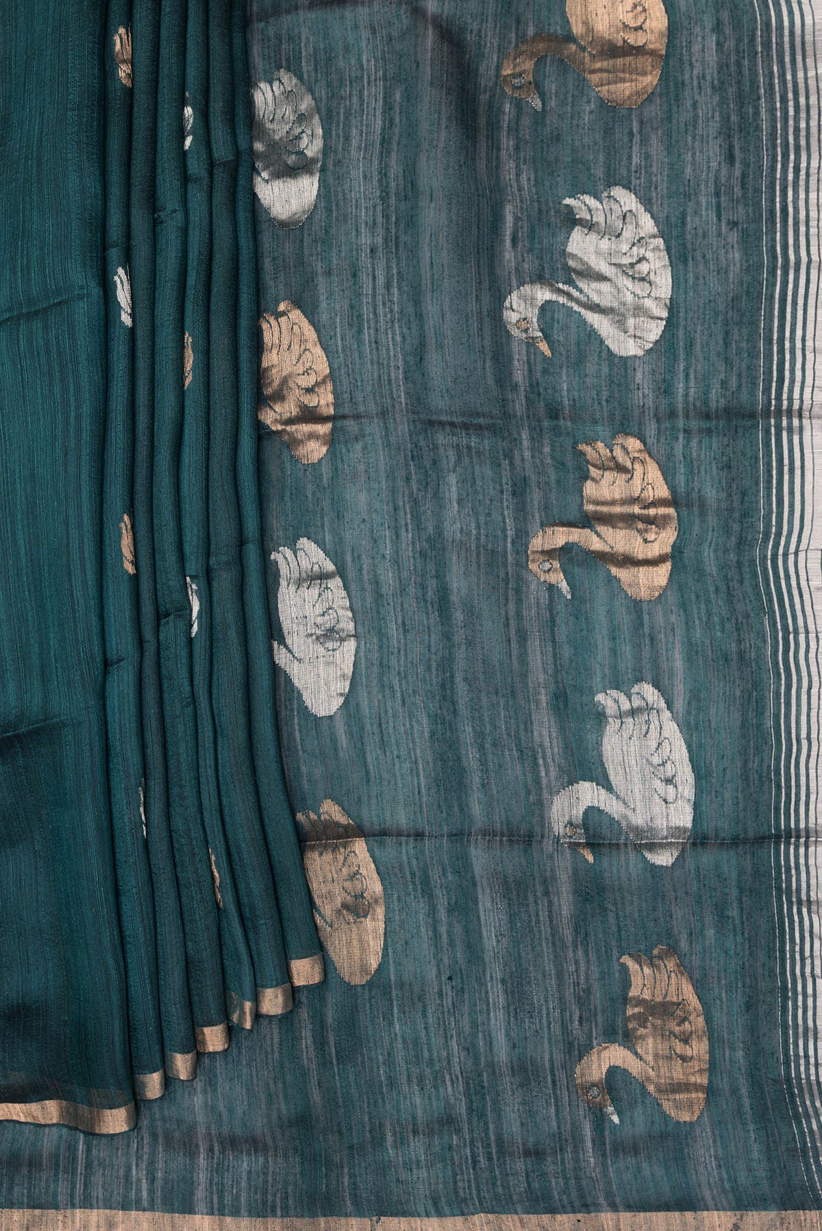 Pleats and pallu of Pure Silk Bottle Green Tussar Saree with Zari Butta on the body and Zari Border. 