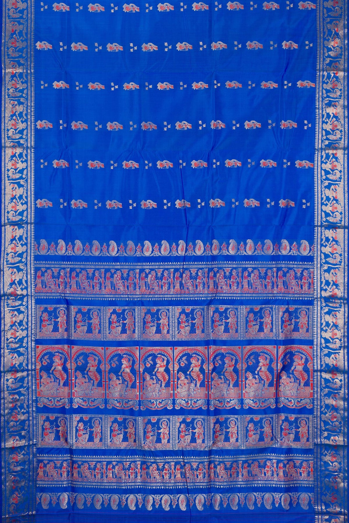 Flat view of Pure Silk Royal Blue Baluchari Saree with Zari And Thread Butta on the body and Zari Border. 