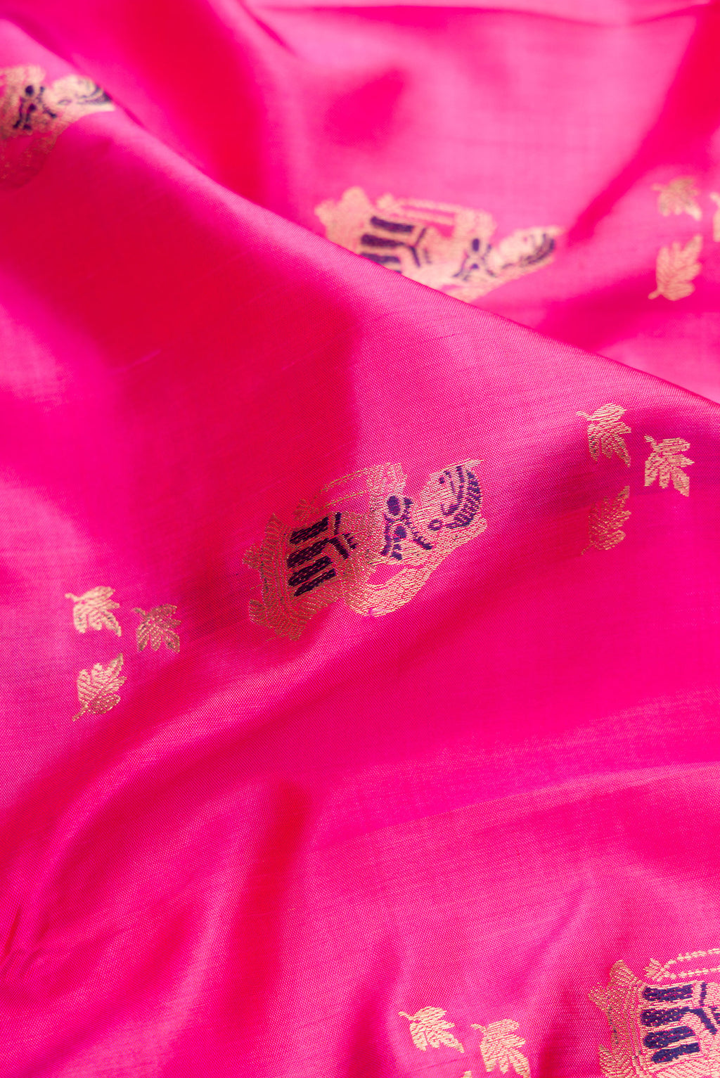 Close up of Pure Silk Pink Baluchari Saree with Zari And Thread Butta on the body and Fancy Border.  displaying folds