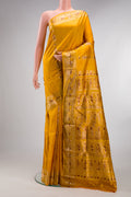 Pure Silk Mustard Baluchari Saree with Zari And Thread Butta on the body and Fancy Border.  displayed on a mannequin