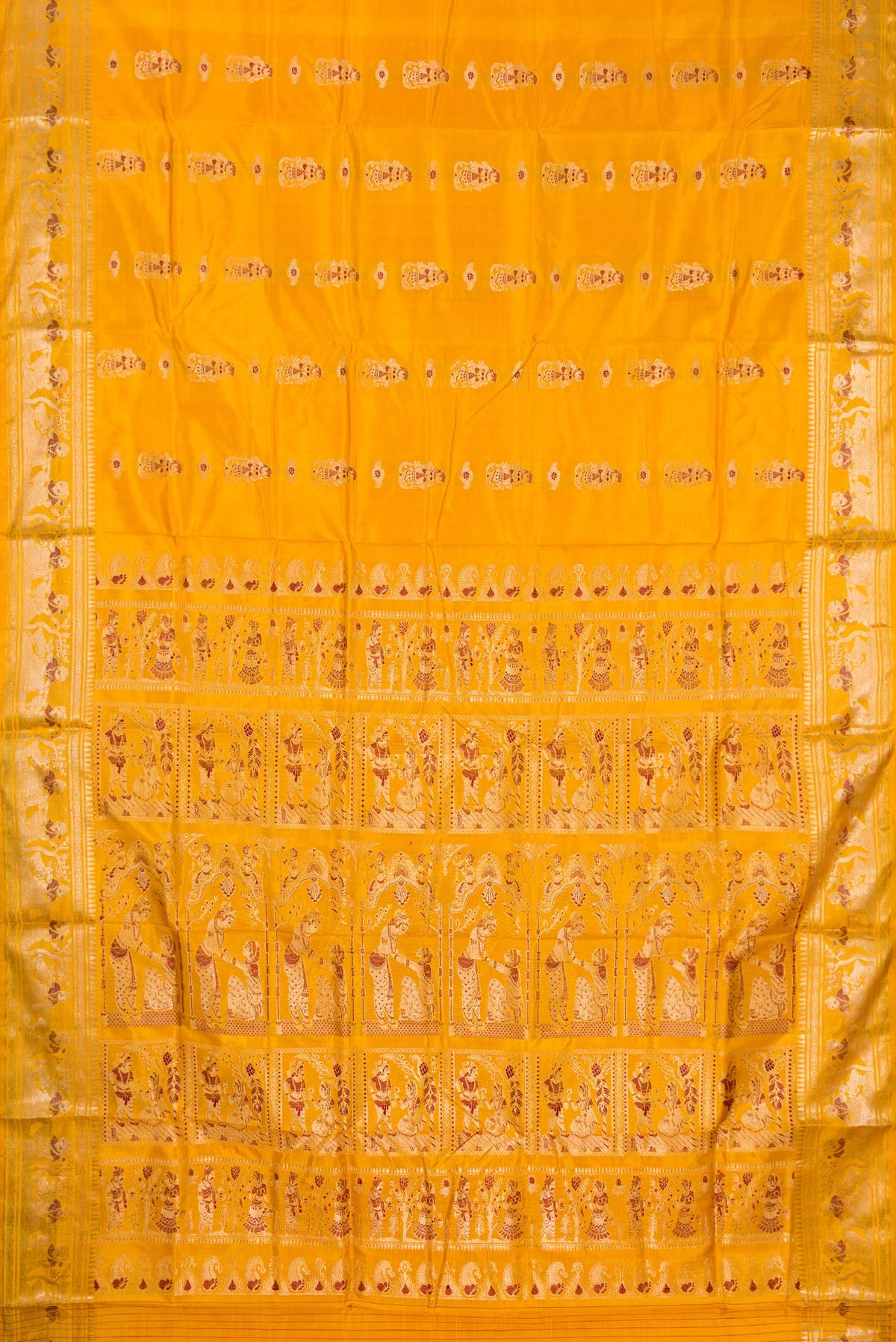Flat view of Pure Silk Mustard Baluchari Saree with Zari And Thread Butta on the body and Fancy Border. 