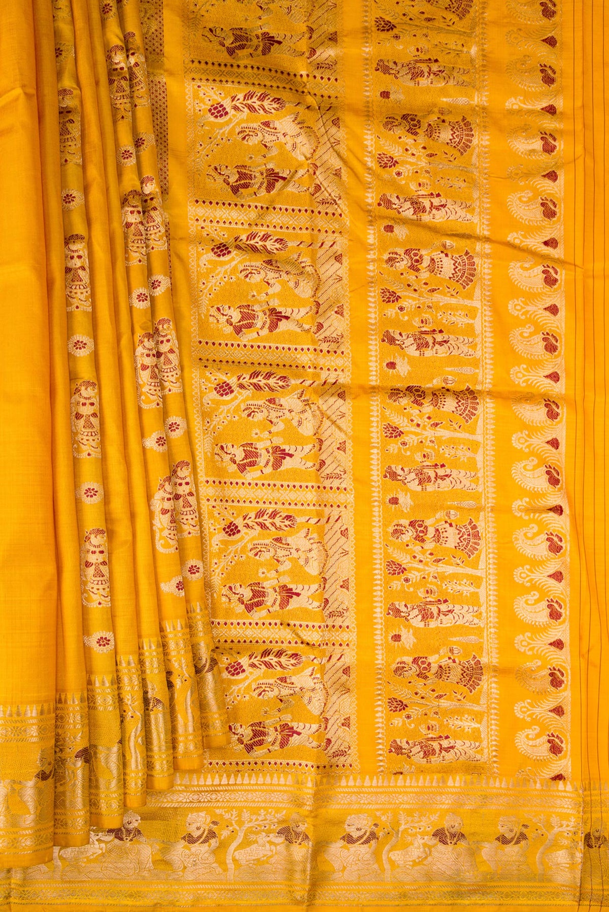 Pleats and pallu of Pure Silk Mustard Baluchari Saree with Zari And Thread Butta on the body and Fancy Border. 
