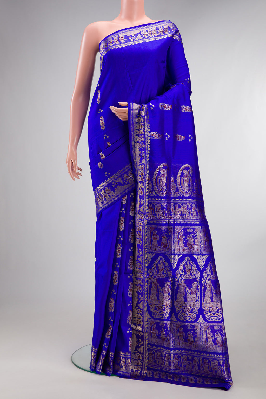 Pure Silk Royal Blue Baluchari Saree with Zari And Thread Butta on the body and Fancy Border.  displayed on a mannequin