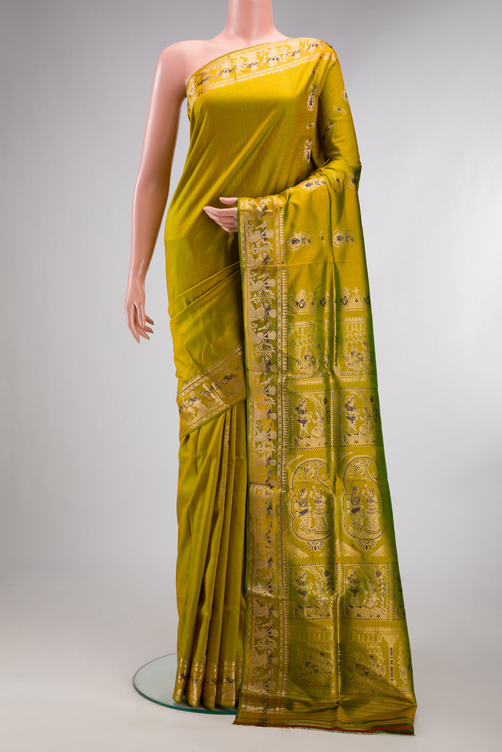 Pure Silk Mehandi Green Dual Tone Baluchari Saree with Zari And Thread Butta on the body and Fancy Border.  displayed on a mannequin