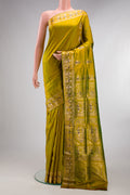 Pure Silk Mehandi Green Dual Tone Baluchari Saree with Zari And Thread Butta on the body and Fancy Border.  displayed on a mannequin