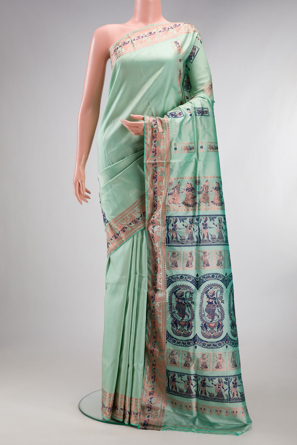 Pure Silk Pista Green Baluchari Saree with Zari And Thread Butta on the body and Fancy Border.  displayed on a mannequin