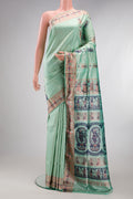 Pure Silk Pista Green Baluchari Saree with Zari And Thread Butta on the body and Fancy Border.  displayed on a mannequin