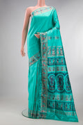 Pure Silk Turquoise Baluchari Saree with Zari And Thread Butta on the body and Fancy Border.  displayed on a mannequin