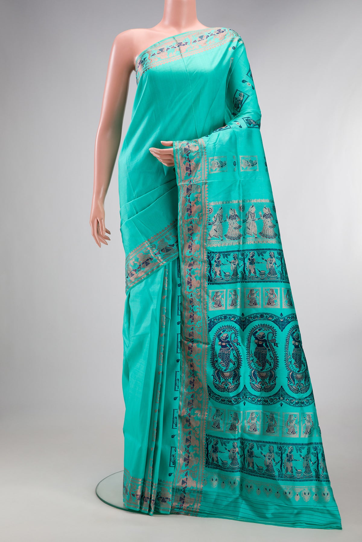 Pure Silk Turquoise Baluchari Saree with Zari And Thread Butta on the body and Fancy Border.  displayed on a mannequin