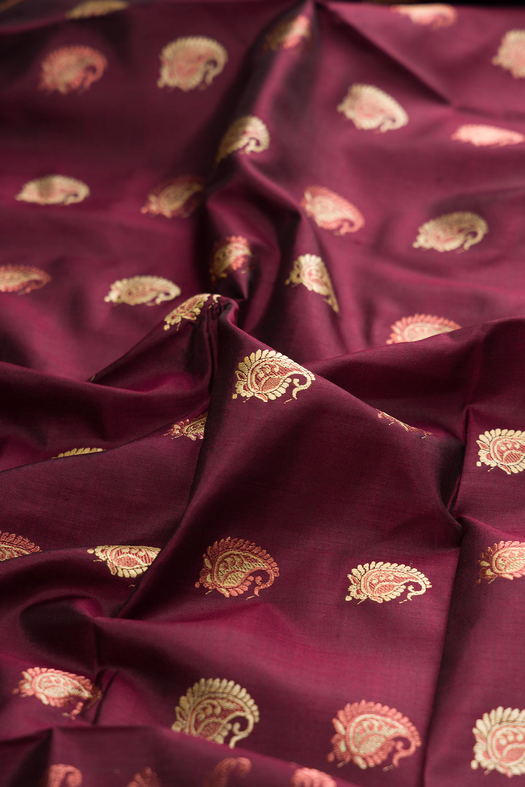 Close up of Pure Silk Coffee Brown Baluchari Saree with Zari And Thread Butta on the body and Zari And Thread Border.  displaying folds