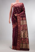 Pure Silk Coffee Brown Baluchari Saree with Zari And Thread Butta on the body and Zari And Thread Border.  displayed on a mannequin