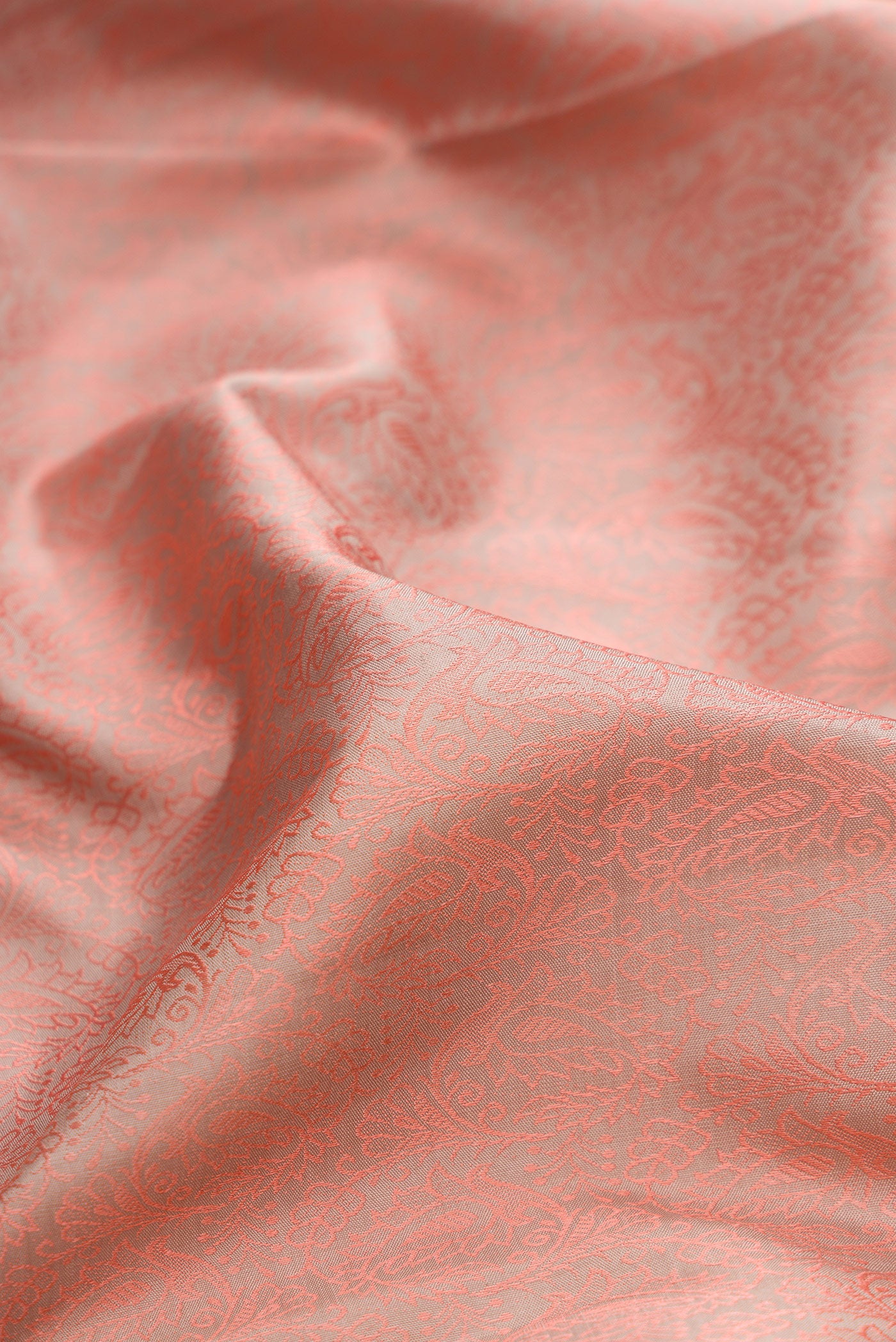 Close up of Pure Silk Rose Gold Kanchipuram Saree with Jacquard design on the body and Zari Border.  displaying folds