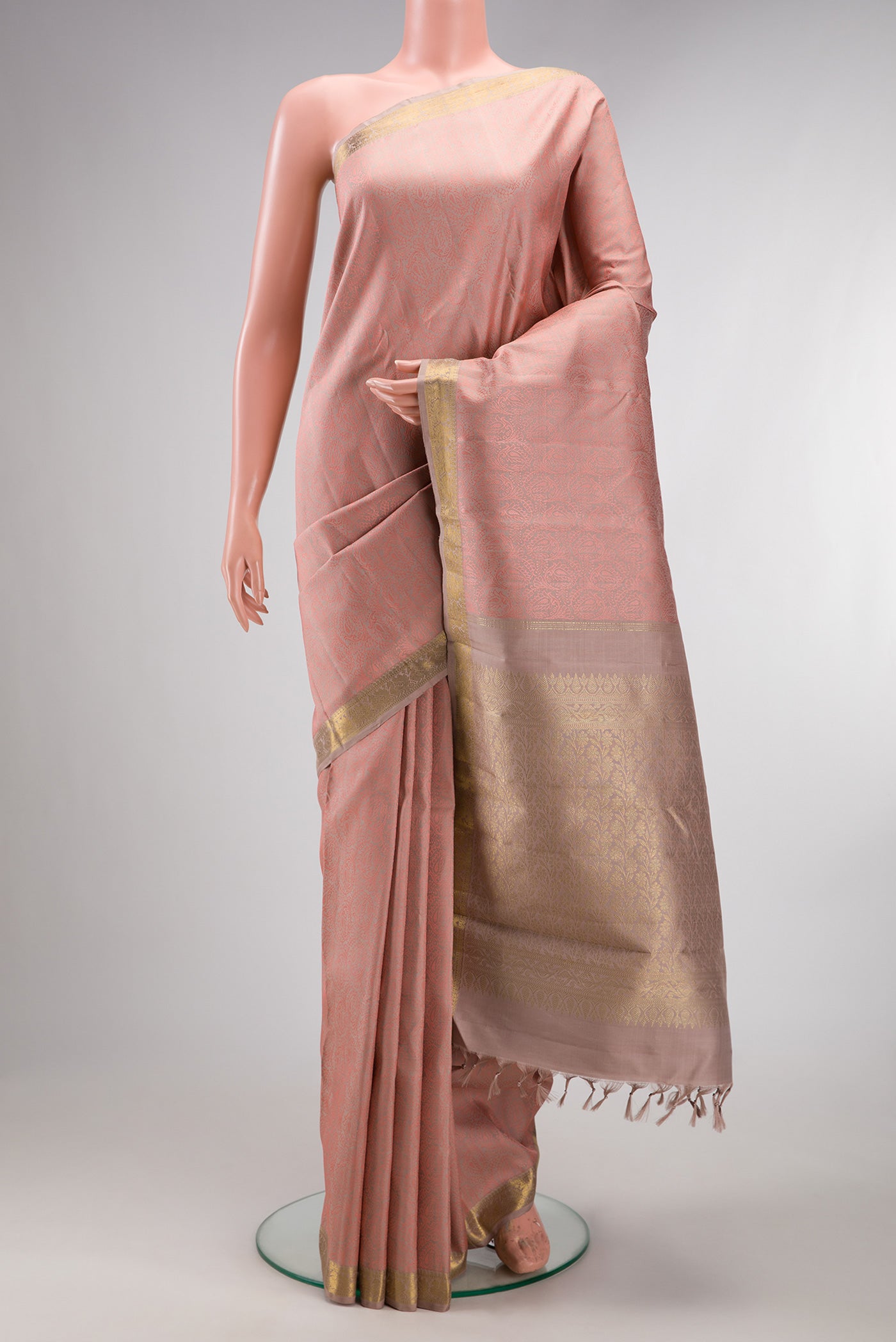 Pure Silk Rose Gold Kanchipuram Saree with Jacquard design on the body and Zari Border.  displayed on a mannequin