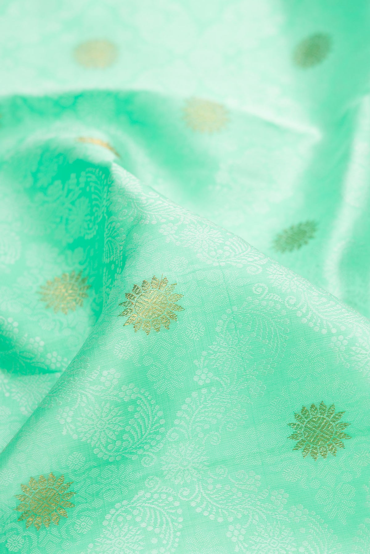 Close up of Pure Silk Pure Zari Sea Green Kanchipuram Saree with Jacquard design on the body and Zari Border.  displaying folds