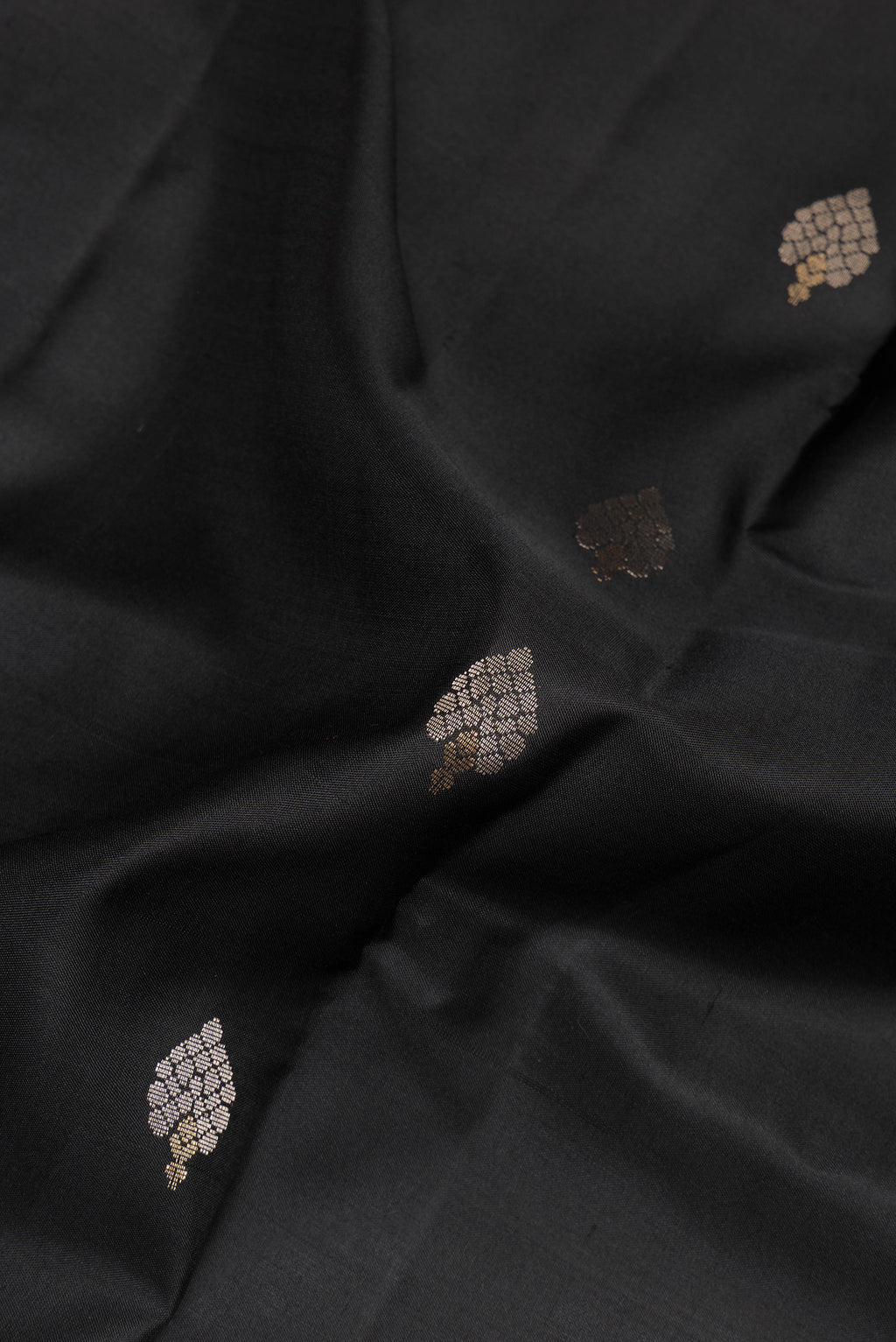 Close up of Pure Silk Black Dual Tone Soft Saree with Zari Butta on the body and Zari Border.  displaying folds