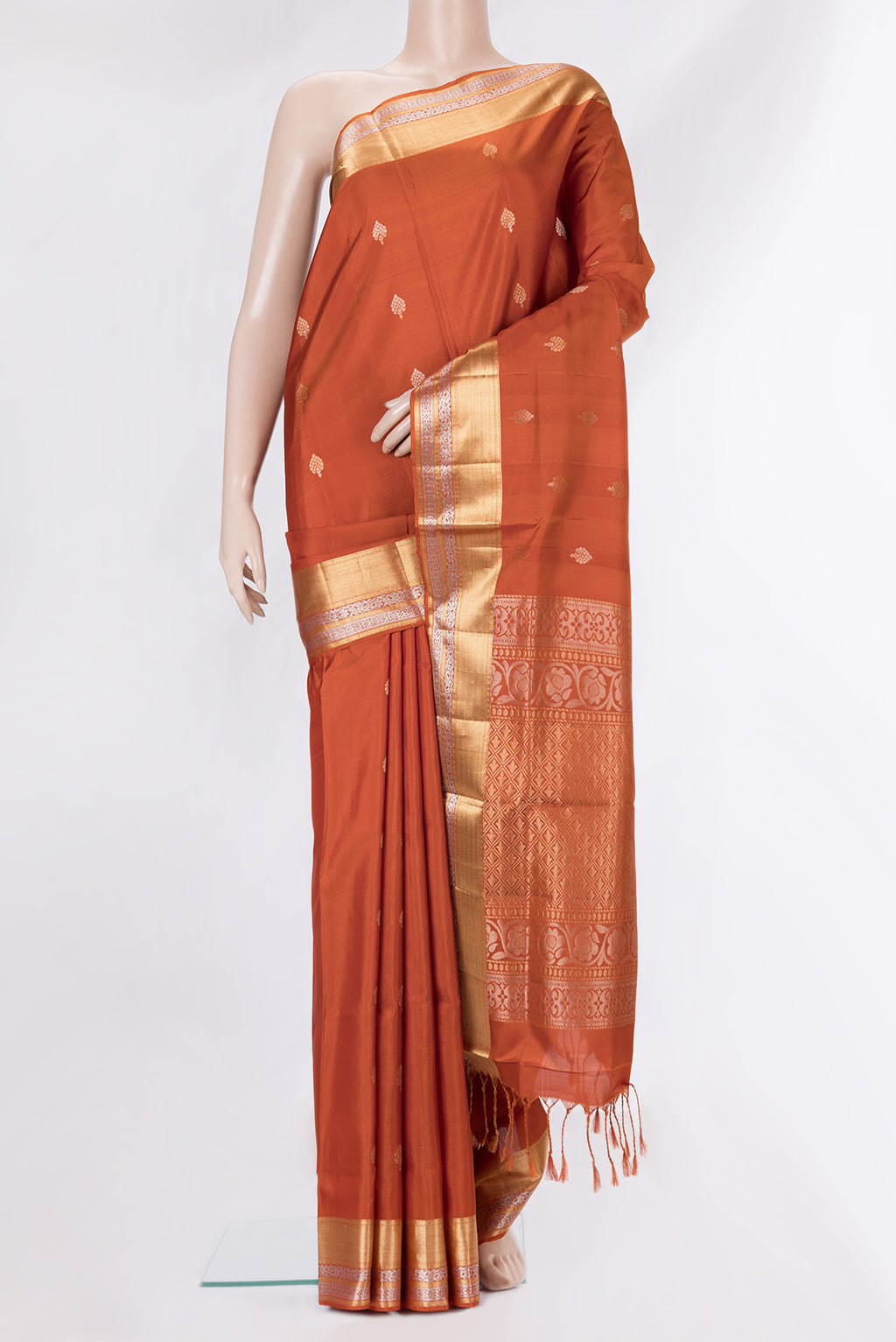 Pure Silk Rust Dual Tone Soft Saree with Zari Butta on the body and Zari Border.  displayed on a mannequin