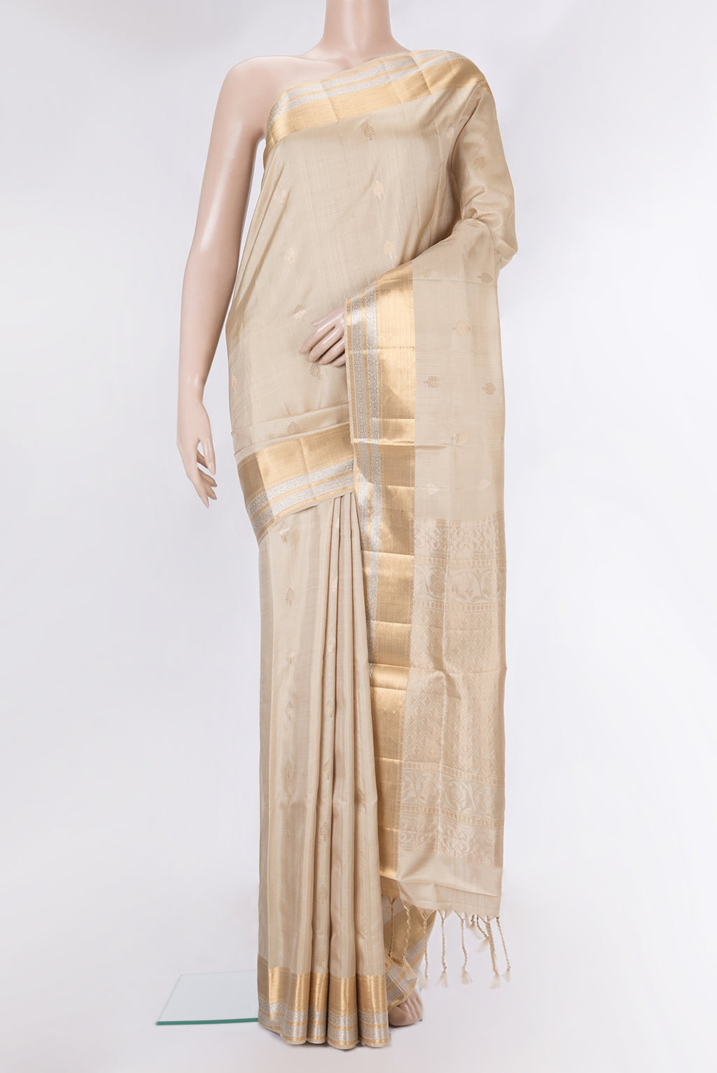 Pure Silk Beige Dual Tone Soft Saree with Zari Butta on the body and Zari Border.  displayed on a mannequin