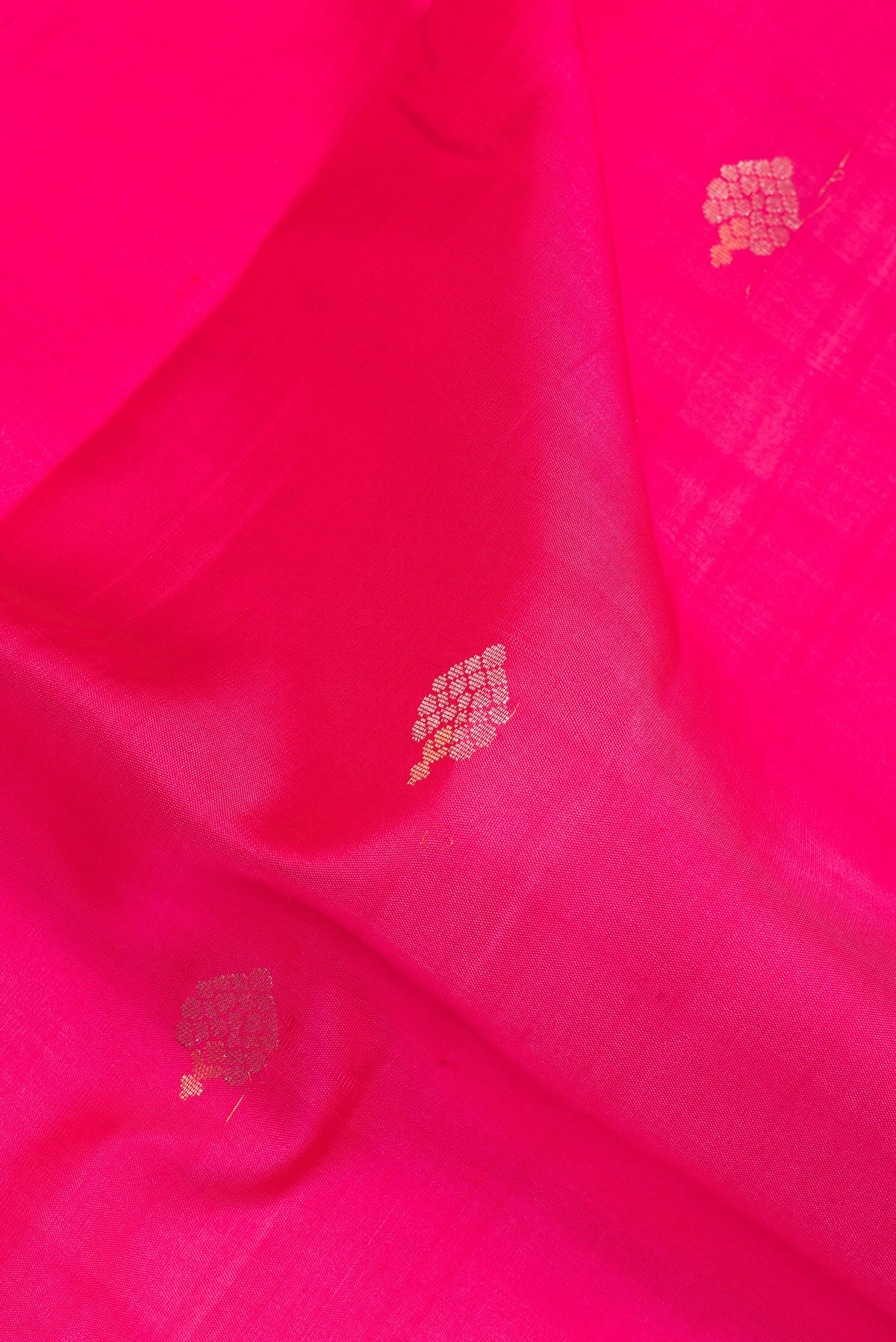 Close up of Pure Silk Rose pink Dual Tone Soft Saree with Zari Butta on the body and Zari Border.  displaying folds