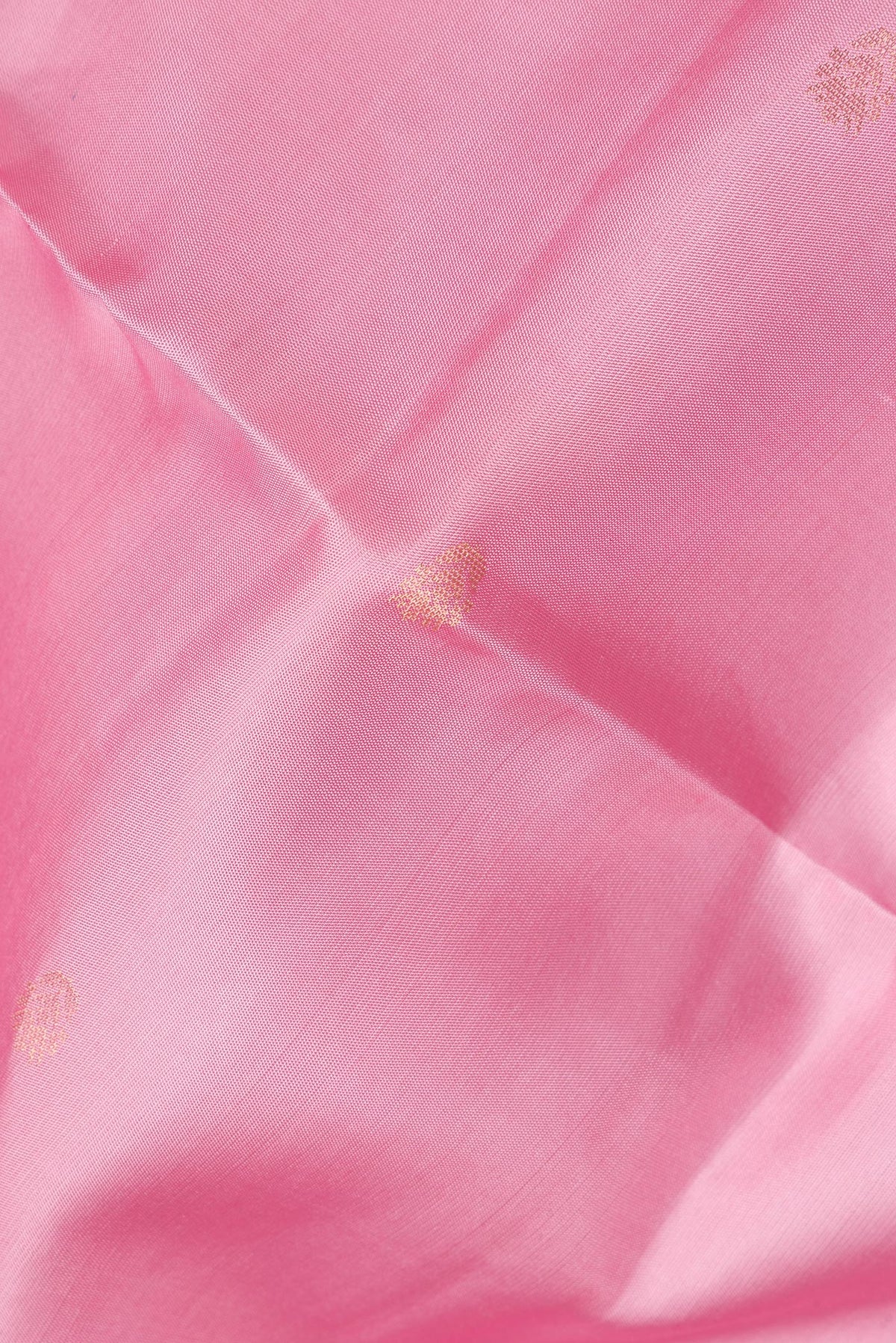 Close up of Pure Silk Rose pink Dual Tone Soft Saree with Zari Butta on the body and Zari Border.  displaying folds