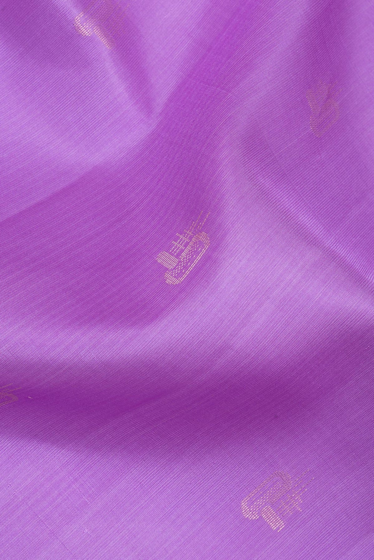Close up of Pure Silk Lavender Soft Saree with Zari Butta on the body and Zari Border.  displaying folds