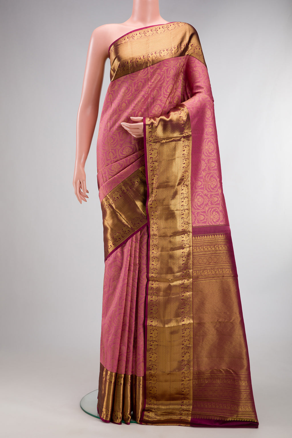 Pure Silk Rose pink Kanjivaram Saree with Zari Brocade on the body and Zari Border.  displayed on a mannequin