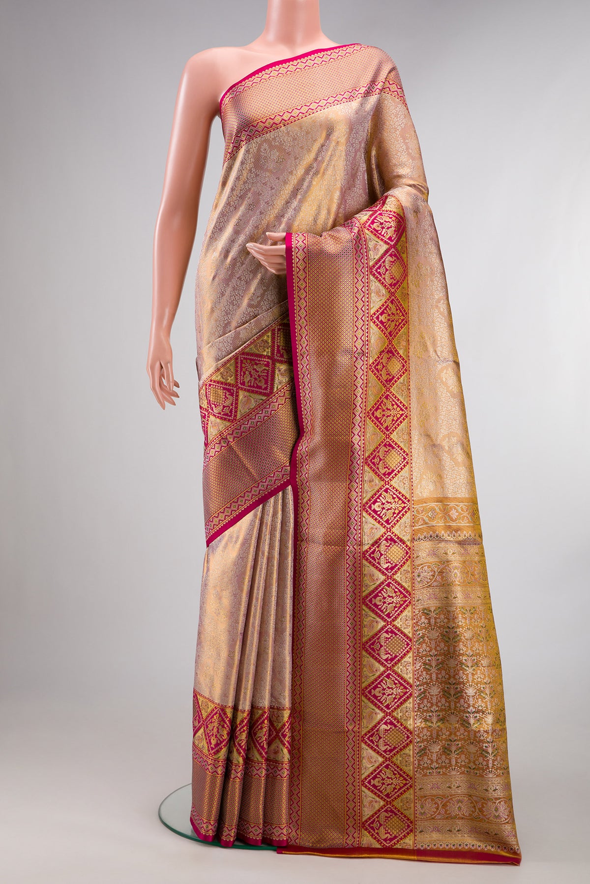 Rose Gold Dual Tone Kanchipuram Tissue Saree with Zari Brocade on the body and Fancy Border.  displayed on a mannequin