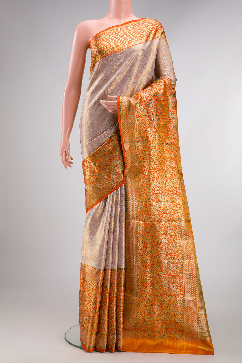 Rose Gold Dual Tone Kanchipuram Tissue Saree with Zari Brocade on the body and Fancy Border.  displayed on a mannequin