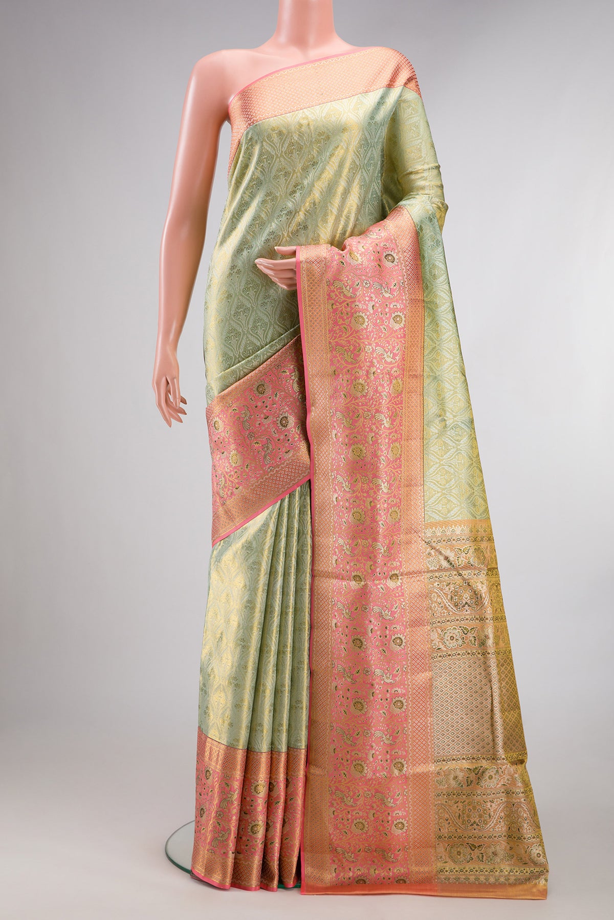 Pista Green Dual Tone Kanchipuram Tissue Saree with Zari Brocade on the body and Fancy Border.  displayed on a mannequin